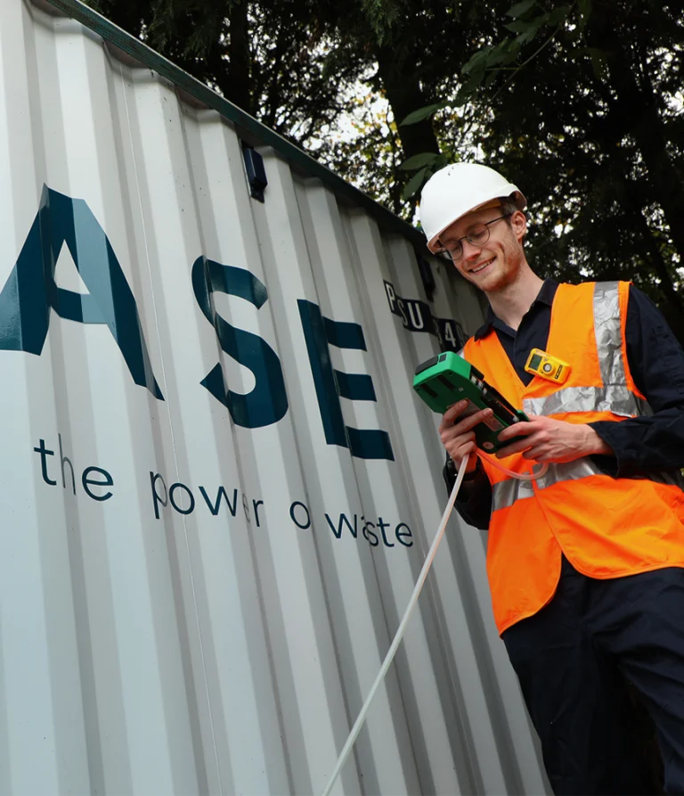 Image of WASE engineer stood next to a WASE reactor