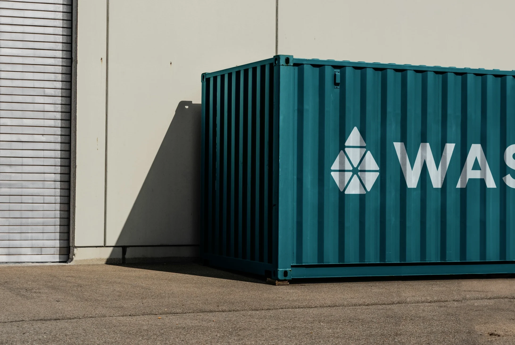Image depicting a WASE electro-methanogenesis reactor in a shipping container with a WASE logo on the side.